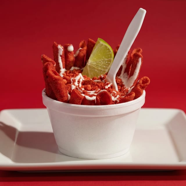 Elotes with Takis or Hot Cheetos.